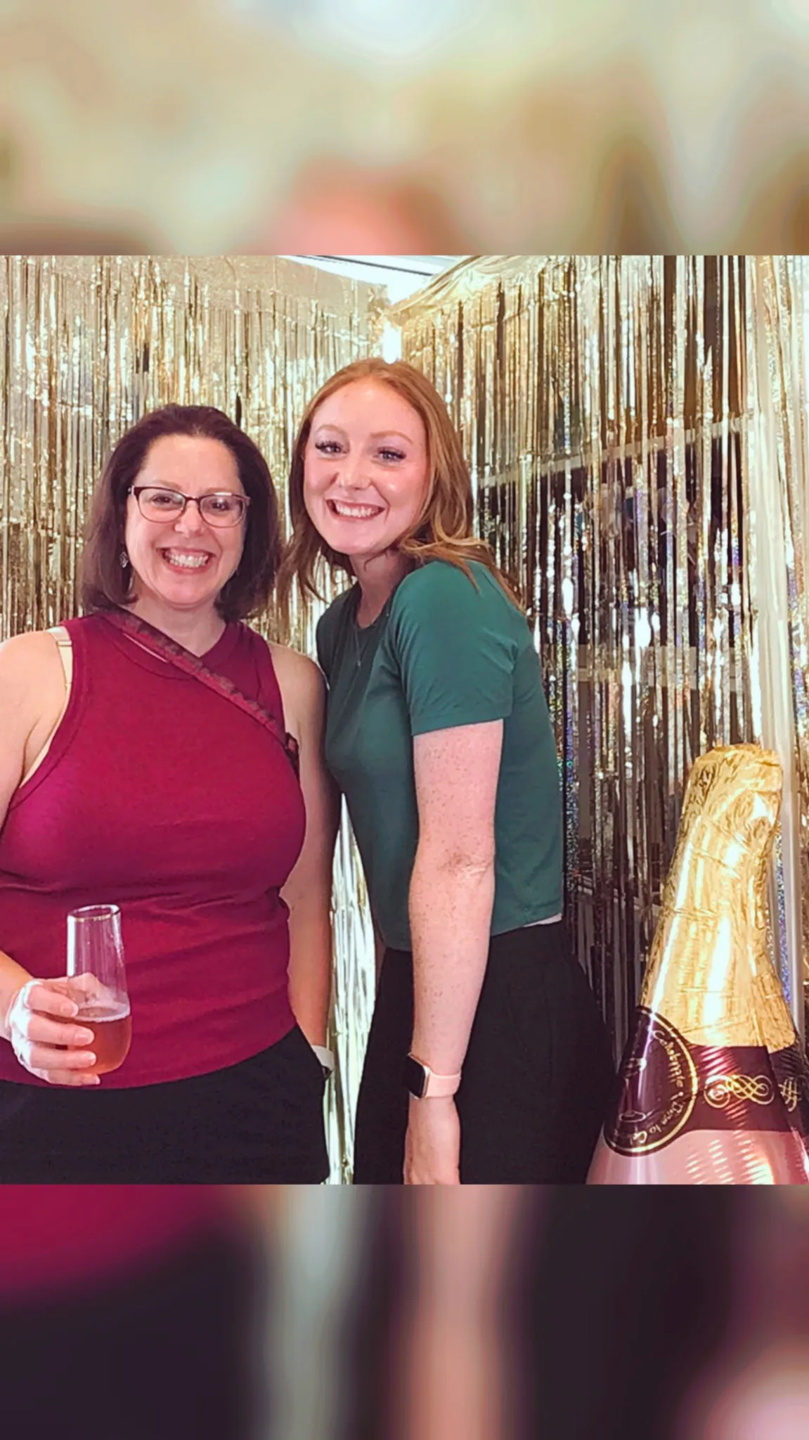 Guests laughing together at the Sip & Sculpt photo wall