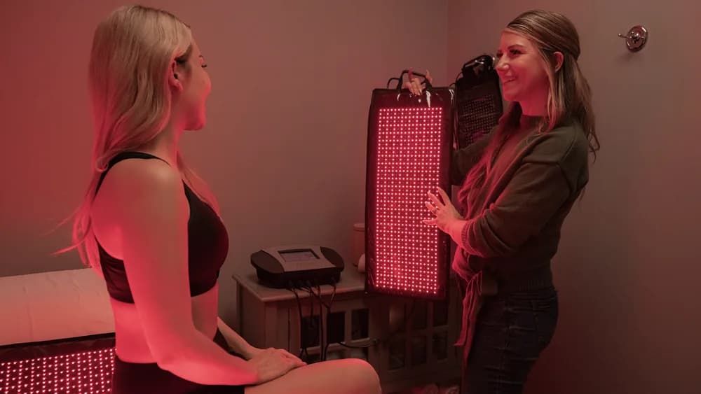 A woman relaxing during a red light therapy session